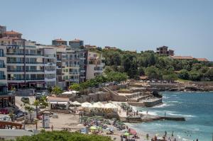 a group of people on a beach near the water at Queen Apartments & Rooms in Dobra Voda