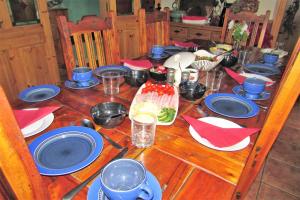 a wooden table with blue and red plates on it at Breacan Cottage B&B in Kinvara