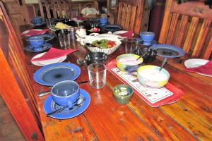 a wooden table topped with plates and bowls of food at Breacan Cottage B&B in Kinvara