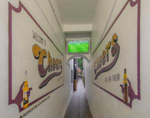 a hallway of a building with signs on the wall at Cheers Cafe Bar & Tavern in Fraserburgh