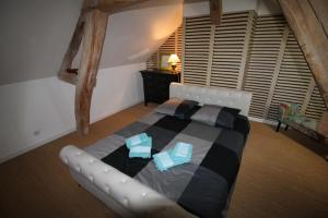 a bedroom with a large bed with two pillows at Maison IZARO in Précy-Saint-Martin