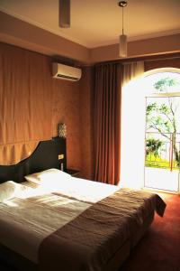 A bed or beds in a room at Agama Hotel