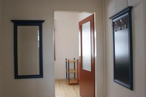 a hallway with a door and a mirror on a wall at Penzion Apartmán Janov in Janov nad Nisou