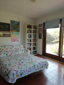 a bedroom with a bed and a book shelf at Casa Gelsomino in Carlentini