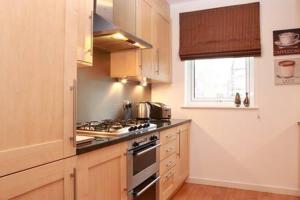 a kitchen with a stove and a window in it at The Park - Holyrood Road with Free Parking in Edinburgh