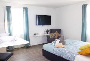 a bedroom with a bed with a hat and a chair at Apartments Borghetto in Vinkuran +37 photos