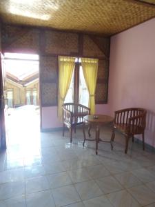 a room with two chairs and a table at Pondok Stevia Ciwidey in Ciwidey