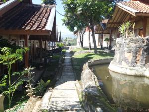 a street in a village with a pond at Pondok Stevia Ciwidey in Ciwidey