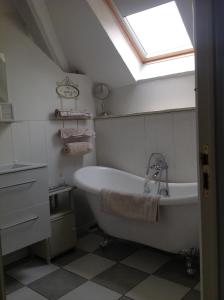 a bathroom with a bath tub and a skylight at Le Domaine in Lignac