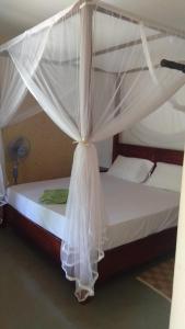 Säng eller sängar i ett rum på Taragala Chalets
