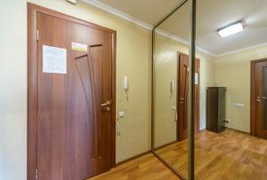 a hallway with two doors and a mirror at Prospekt Geroiv Stalingradu Apartments in Kyiv