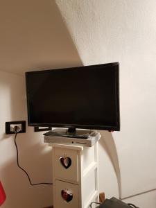 a flat screen tv sitting on top of a table at Il Dammuso di Tanit in Pantelleria