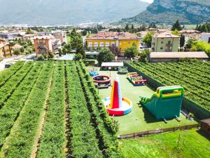 an outdoor play area with a playground in a garden at Hotel Campagnola in Riva del Garda