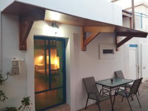 a patio with a table and chairs in a house at Beachfront Apartment Kato Zakros in Kato Zakros