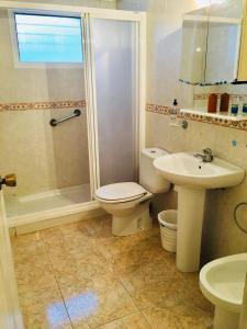 a bathroom with a toilet and a sink and a shower at Teniente Ruiz 27 in Elche