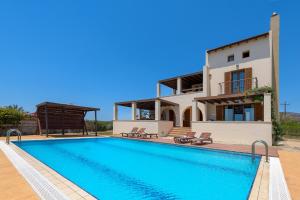 a villa with a swimming pool and a house at Villa Lahania in Lachania