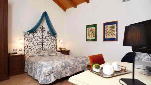 a bedroom with a bed with a blue and white headboard at Locanda Del Borgo in Sestri Levante