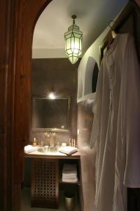 a bathroom with a sink and a mirror at Riad CHERRATA in Marrakesh