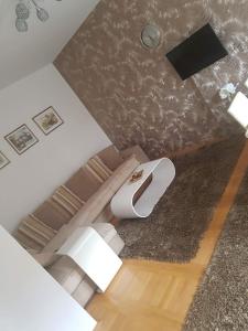 an overhead view of a bedroom with a toilet and a television at Harmony apartman in Bijeljina
