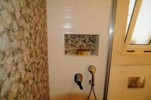 a shower with a blow dryer in a bathroom at Grand Alaçatı Butik Hotel in Alaçatı