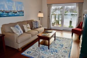 a living room with a couch and a table at St Michaels Harbour Inn, Marina and Spa in Saint Michaels