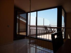 a room with a balcony with a view of the ocean at Hotel Verti in Corró de Vall