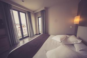 Postel nebo postele na pokoji v ubytování Hotel Aroi Ponferrada