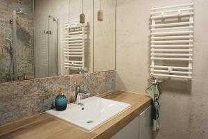 a bathroom with a sink and a mirror at Biały Domek in Tylmanowa