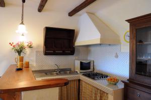 a kitchen with a sink and a stove at Villa Eleanto in Cefalù