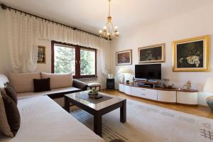 a living room with a couch and a tv at Old Town House in Sarajevo in Sarajevo