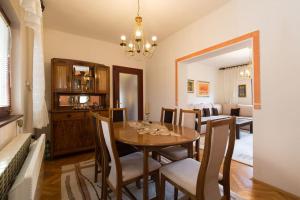 a dining room with a wooden table and chairs at Old Town House in Sarajevo in Sarajevo
