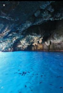a view of a blue cave with water in it at Pousada Romantica in Tropea