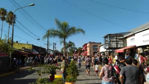 a crowd of people walking down a busy street at Departamento céntrico en Tigre in Tigre