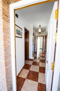 a hallway of a house with a checkerboard floor at Casa Saki in Armilla