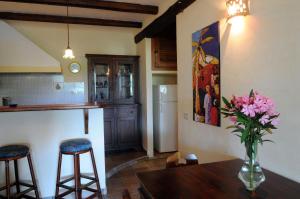 a kitchen with a table and a vase with flowers on it at Villa Eleanto in Cefalù