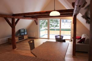 a living room with a table and a couch at Haus der Berge in Braunlage