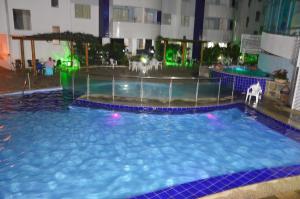 a large swimming pool in a hotel room at Águas da serra in Rio Quente
