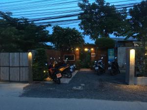 a group of motorcycles parked in a garage at night at Benjamin's Hut in Srithanu