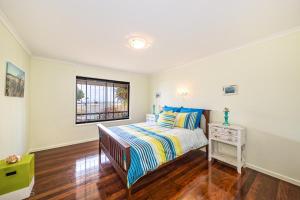 A bed or beds in a room at Beachfront at Bribie