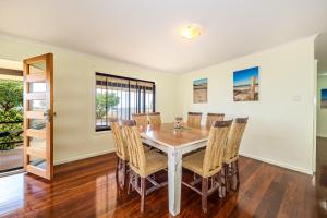 a dining room with a table and chairs at Beachfront at Bribie in Woorim