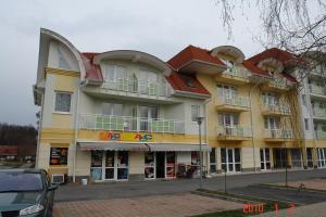 a large building with balconies on a street at Lilla Wellnessapartman in Zalakaros