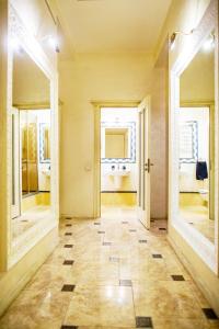 リヴィウにあるApartment On Hutsulskaの廊下(鏡2つ付)、バスルーム(洗面台付)