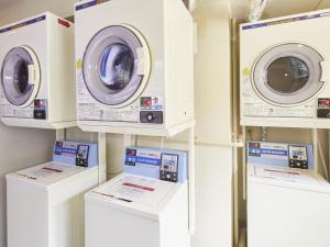 a row of washing machines in a laundry room at Hotel Roco Inn Okinawa in Naha