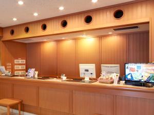 a food counter in a restaurant with avertisement at Hotel Roco Inn Okinawa in Naha