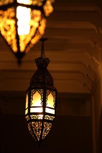a lantern hanging from a ceiling with a window at Riad CHERRATA in Marrakesh