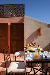 a table with food on it on a patio at Riad CHERRATA in Marrakech