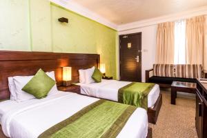 Voodi või voodid majutusasutuse Ceylon City Hotel,Colombo toas