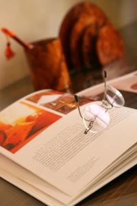 a book with glasses on top of it on a table at Riad CHERRATA in Marrakech