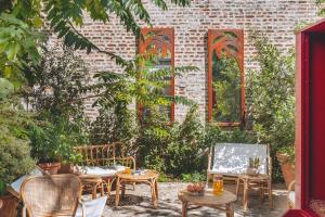 a patio with tables and chairs in front of a brick building at ibis Styles Paris Nation Cours de Vincennes in Paris