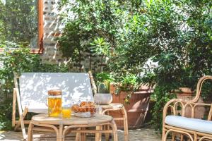 a table with drinks and a bowl of fruit on a patio at ibis Styles Paris Nation Cours de Vincennes in Paris